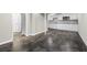 Open basement area with kitchenette, dark flooring and neutral colored walls leading to doorways at 1985 Thomasville Se Dr, Atlanta, GA 30315