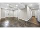 Open basement living area with neutral walls, dark flooring, and multiple doorways at 1985 Thomasville Se Dr, Atlanta, GA 30315