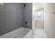 Bathroom with gray subway tiles, bathtub, and bright white marble floors at 1985 Thomasville Se Dr, Atlanta, GA 30315