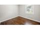 Bedroom with hardwood floors, one window providing ample natural light, neutral wall colors at 1985 Thomasville Se Dr, Atlanta, GA 30315