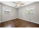 Bedroom with hardwood floors, two windows providing ample natural light and fan with lights at 1985 Thomasville Se Dr, Atlanta, GA 30315