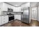 Bright kitchen features stainless steel appliances, granite countertops, and white cabinetry at 1985 Thomasville Se Dr, Atlanta, GA 30315