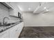 Basement kitchen featuring white cabinetry, subway tile backsplash, granite countertops and stainless steel appliances at 1985 Thomasville Se Dr, Atlanta, GA 30315