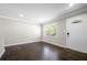 Bright living room with decorative trim, hardwood floors and natural light from large windows at 1985 Thomasville Se Dr, Atlanta, GA 30315