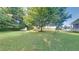 Lush green backyard featuring mature trees and shed at 200 Compton Ct, Mcdonough, GA 30252