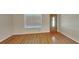 Inviting living area showcasing sleek hardwood floors, a bright window and a stylish front door at 200 Compton Ct, Mcdonough, GA 30252