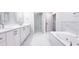 Modern bathroom with double vanity, marble floors and spa tub at 4541 Meadow Club Dr, Suwanee, GA 30024