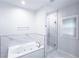 Bright bathroom features a soaking tub and frameless glass shower with white marble tiling at 4541 Meadow Club Dr, Suwanee, GA 30024