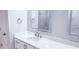 White cabinets, stone countertops, and large frameless LED mirrors in a bright modern bathroom at 4541 Meadow Club Dr, Suwanee, GA 30024