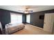 A bedroom with carpet, a ceiling fan, and two bright windows dressed with white blinds at 4541 Meadow Club Dr, Suwanee, GA 30024