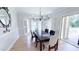 Bright dining room with hardwood floors, bay windows, and a modern chandelier at 4541 Meadow Club Dr, Suwanee, GA 30024