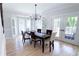 Elegant dining area with chandelier, French doors and bay window at 4541 Meadow Club Dr, Suwanee, GA 30024