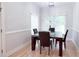 Bright dining room featuring a dark wood table, leather chairs, and natural light at 4541 Meadow Club Dr, Suwanee, GA 30024