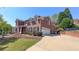 Charming two-story brick home with a two-car garage and a well-maintained lawn at 4541 Meadow Club Dr, Suwanee, GA 30024