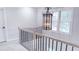 Upstairs hallway featuring a modern chandelier and a window with natural light at 4541 Meadow Club Dr, Suwanee, GA 30024