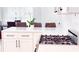 Bright kitchen island with a stove and a modern white countertop at 4541 Meadow Club Dr, Suwanee, GA 30024