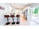 Open kitchen with island, stainless steel appliances, and access to the outdoor space at 4541 Meadow Club Dr, Suwanee, GA 30024