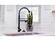 Close up of kitchen sink with black faucet and white tile backsplash at 4541 Meadow Club Dr, Suwanee, GA 30024