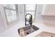 Stainless steel kitchen sink with industrial faucet, under a bright window at 4541 Meadow Club Dr, Suwanee, GA 30024