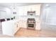 Modern kitchen with stainless steel range, white cabinets and a white quartz countertop at 4541 Meadow Club Dr, Suwanee, GA 30024