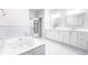 Bright main bathroom with a large soaking tub and dual vanities at 4541 Meadow Club Dr, Suwanee, GA 30024