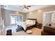 Spacious main bedroom featuring a tray ceiling, ceiling fan, and large bed at 4541 Meadow Club Dr, Suwanee, GA 30024