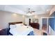 Spacious main bedroom featuring a tray ceiling, ceiling fan, and large bed at 4541 Meadow Club Dr, Suwanee, GA 30024