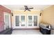 Covered patio with brick accents, ceiling fan, and grill, perfect for outdoor entertaining at 4541 Meadow Club Dr, Suwanee, GA 30024