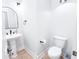 Clean, bright powder room with pedestal sink, modern fixtures, and toilet at 4541 Meadow Club Dr, Suwanee, GA 30024