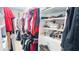 Walk-in closet features custom shelving for clothing, shoes, and accessories at 4541 Meadow Club Dr, Suwanee, GA 30024