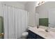 Bathroom featuring a large mirror, neutral countertops, and tiled shower at 9507 Greens Mill Ct, Loganville, GA 30052