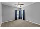 Spacious bedroom featuring neutral walls, carpet and curtains at 9507 Greens Mill Ct, Loganville, GA 30052