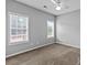 Well-lit bedroom featuring neutral walls, carpet, and a ceiling fan at 9507 Greens Mill Ct, Loganville, GA 30052