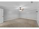 Spacious bedroom with neutral carpet, white trim, and a ceiling fan at 9507 Greens Mill Ct, Loganville, GA 30052