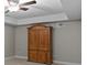 Bedroom features neutral paint, carpet flooring, and a wooden armoire providing ample storage space at 9507 Greens Mill Ct, Loganville, GA 30052