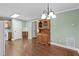 Charming dining area featuring hardwood floors, built-in storage, and a view into the kitchen at 9507 Greens Mill Ct, Loganville, GA 30052