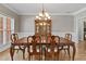 Elegant dining room with hardwood floors, chandelier, and a classic china cabinet at 9507 Greens Mill Ct, Loganville, GA 30052