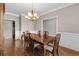 Well-lit dining room with a wooden table and chairs, complemented by crown molding at 9507 Greens Mill Ct, Loganville, GA 30052