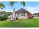 Yard view of home's rear elevation, deck, siding, and brick accents at 9507 Greens Mill Ct, Loganville, GA 30052
