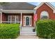 A welcoming front porch with steps leads to a beautifully maintained home at 9507 Greens Mill Ct, Loganville, GA 30052