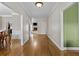 Bright hallway features gleaming hardwood floors and opens to other living spaces at 9507 Greens Mill Ct, Loganville, GA 30052