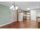 Cozy kitchen with wood cabinets, white appliances, and a charming adjoining dining area at 9507 Greens Mill Ct, Loganville, GA 30052