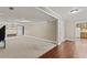 Open-plan living room with both carpeted and hardwood flooring at 9507 Greens Mill Ct, Loganville, GA 30052