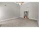 Expansive living room with a ceiling fan, neutral walls, and a cozy carpeted floor at 9507 Greens Mill Ct, Loganville, GA 30052