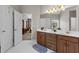 Main bathroom featuring double sinks, white countertops, and access to the main bedroom at 9507 Greens Mill Ct, Loganville, GA 30052