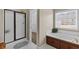 Inviting main bathroom featuring a glass-enclosed shower and large soaking tub with jets at 9507 Greens Mill Ct, Loganville, GA 30052