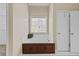 Tranquil main bathroom showcasing a built-in tub, white tile floors, and ample natural light at 9507 Greens Mill Ct, Loganville, GA 30052