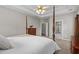 Cozy main bedroom with a four-poster bed, soft carpeting, and an en-suite bathroom at 9507 Greens Mill Ct, Loganville, GA 30052