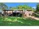 Back exterior of brick home with small upper level deck and views of the green lawn at 1663 Pounds Sw Rd, Stone Mountain, GA 30087