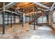 Exposed basement area with unfinished walls, support beams and stairs leading to the first floor at 1663 Pounds Sw Rd, Stone Mountain, GA 30087